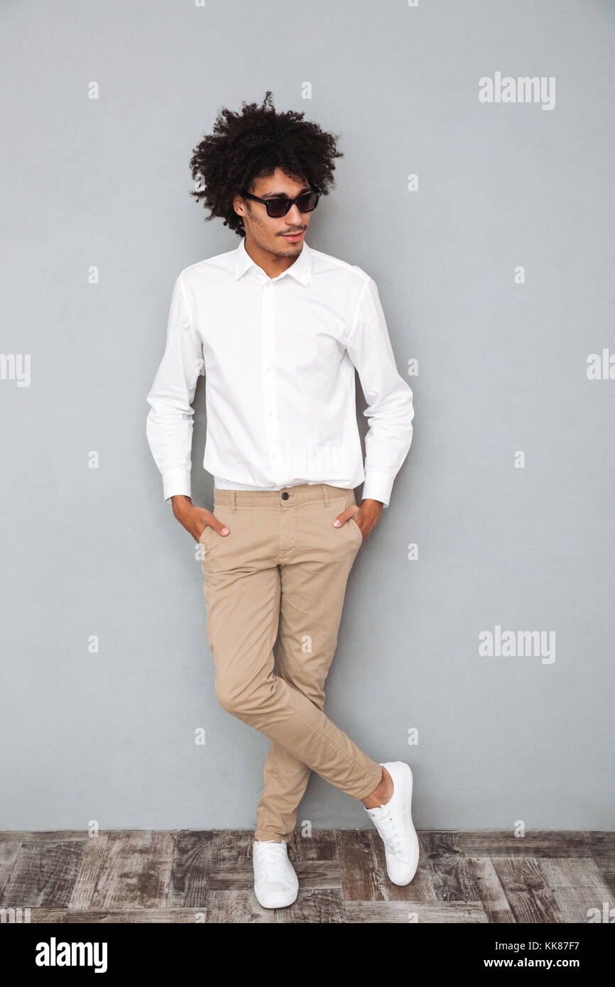 Full length portrait of a confident young african man in white shirt ...