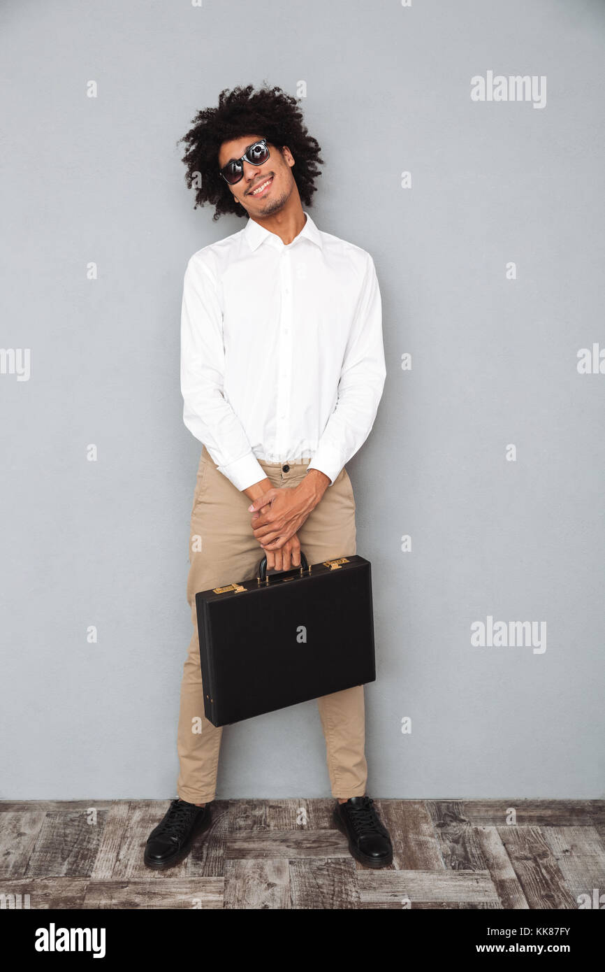 Full length portrait of a successful smiling african man in white shirt ...