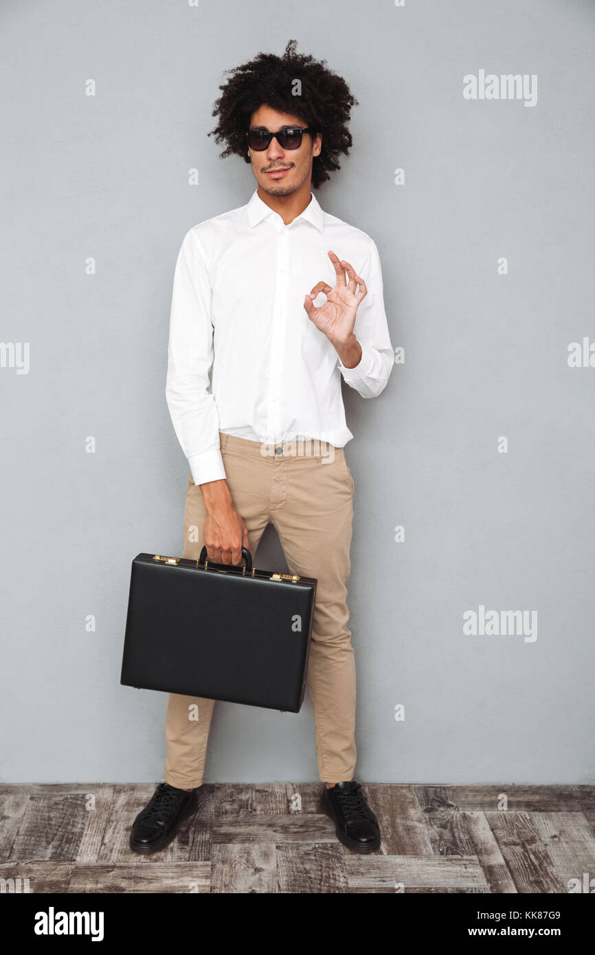 Full length portrait of a successful smiling african man in white shirt ...