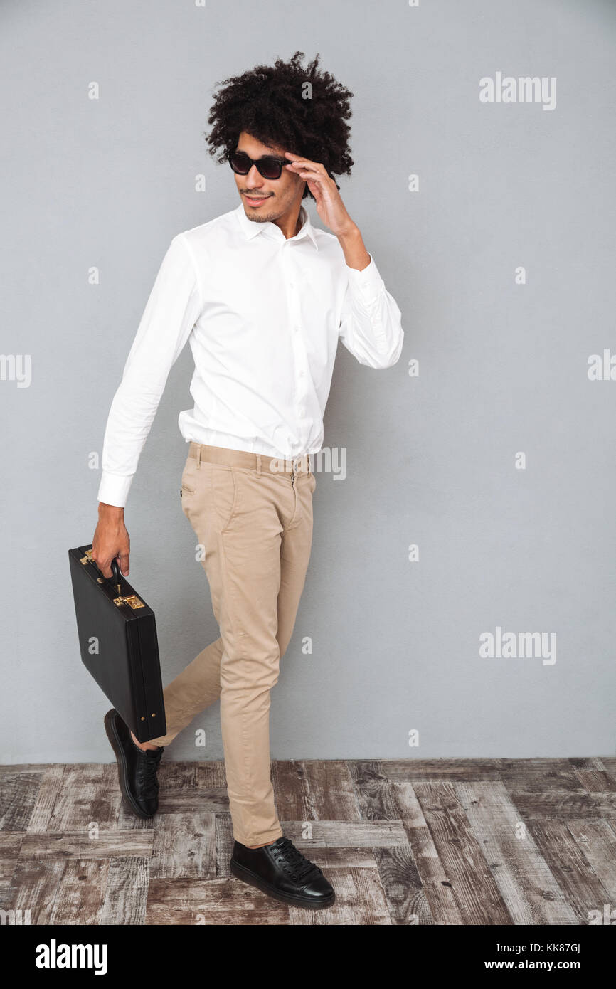 Full length portrait of a young confident african man in white shirt ...