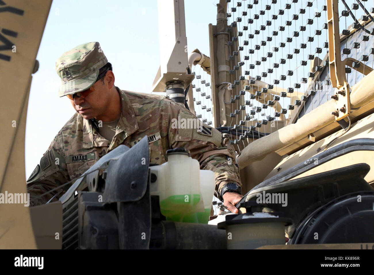 BAGRAM AIRFIELD, Afghanistan - Staff Sgt. Arturo Amaro, the master driver for the 3rd Special Troops Battalion, 3rd Infantry Division Resolute Support Sustainment Brigade, checks fluid levels in a MaxxPro II mine-resistant, ambush-protected vehicle during a master driver training course Nov. 8 at Bagram Airfield, Afghanistan. Amaro is the sole master driver for the 3rd Inf. Div. RSSB and will, once certified through this course, be able to train Soldiers from all over the Command Joint Operations Area - Afghanistan. (U.S. Army photo by Spc. Elizabeth White with 3ID RSSB/Released) Stock Photo