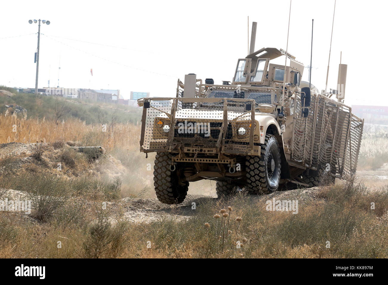 BAGRAM AIRFIELD, Afghanistan - A Oshkosh Defense mine-resistant, ambush-protected vehicle All-Terrain Vehicle (MAT-V) bumps across ruts in the off-road portion of the master driver training course at Bagram Airfield, Afghanistan on Nov. 8. The drivers also conducted a road portion, where they drive through post, as well as a night driving course to familiarize them with driving the vehicle in all types of conditions. (U.S. Army photo by Spc. Elizabeth White with 3ID RSSB/Released) Stock Photo