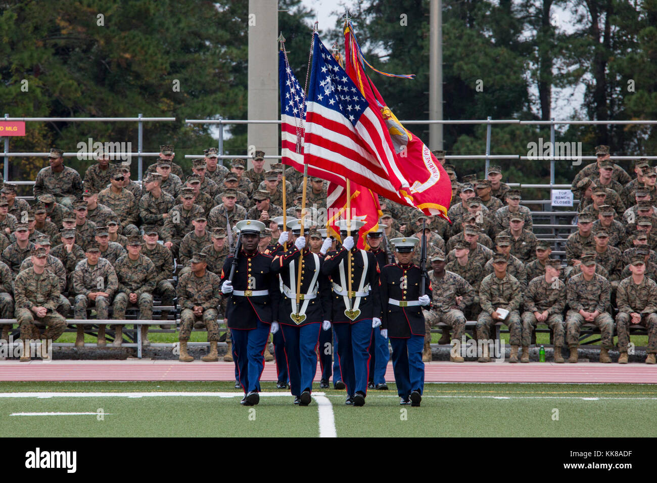 U.S. Marines with color guards from various units march on the colors