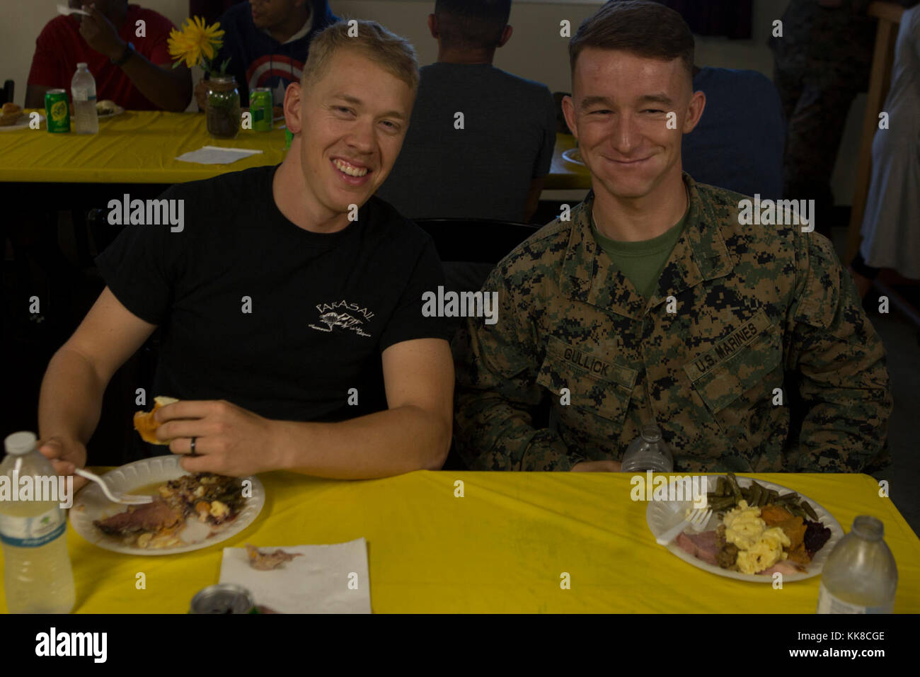 CAMP FOSTER, OKINAWA, Japan – Lance Cpl. Garrett Impola and Lance Cpl. Hunter Gullick pose for a photo during Thanksgiving in the Barracks Nov. 22 aboard Camp Foster, Okinawa, Japan. The dinner was provided by leadership of Headquarters and Support Battalion, Marine Corps Installations Pacific-Marine Corps Base Camp Butler, Japan. The Marines had dinner together to feel a sense of togetherness while away from home this holiday season. The leadership served dinner at barracks aboard Camps Foster, Schwab, Hansen, Courtney, and Kinser and Marine Corps Air Station Futenma. Gullick and Impola are m Stock Photo