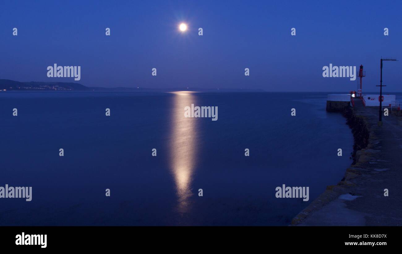 Moonrise over the south east beach Looe in early winter Stock Photo