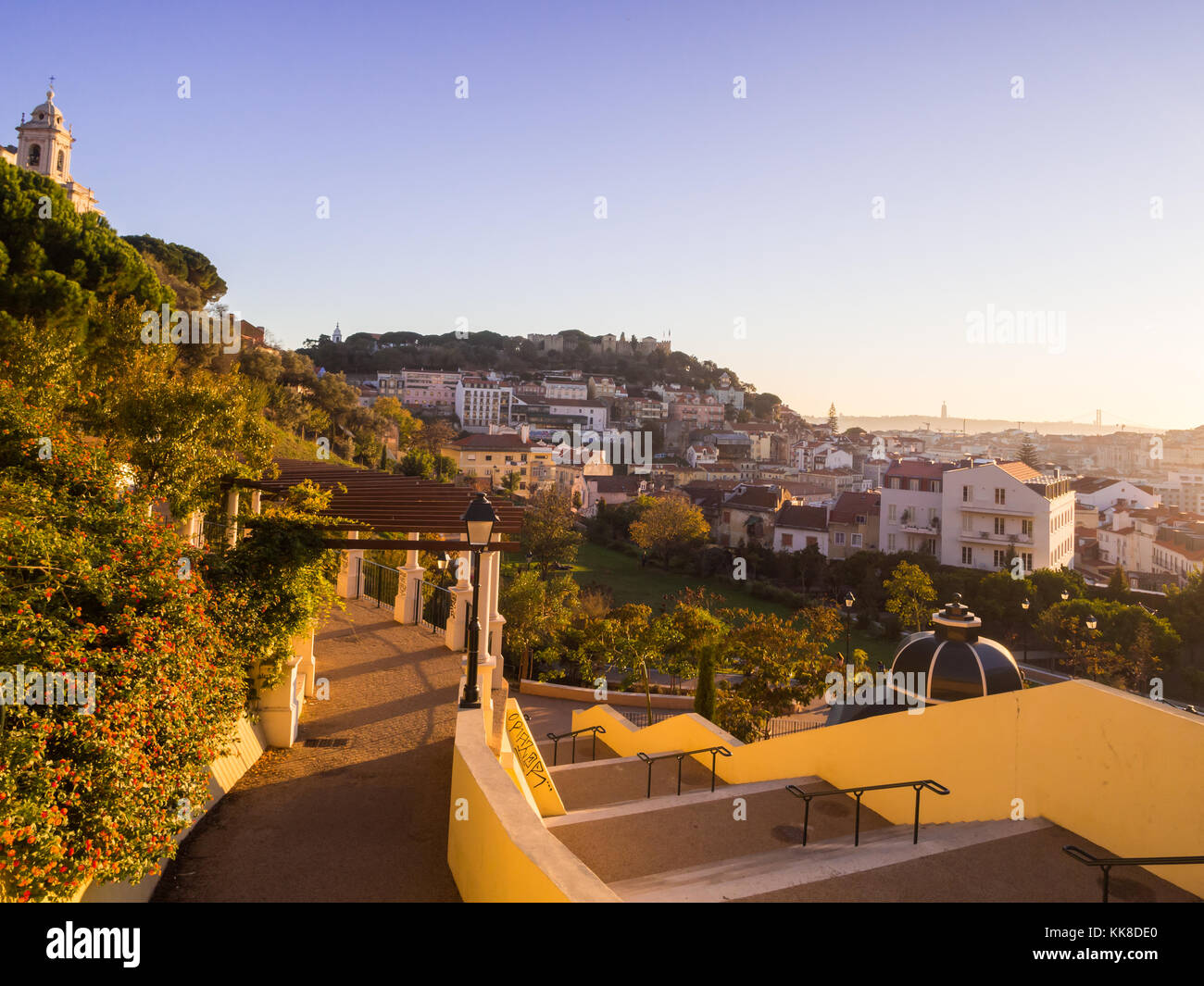LISBON, PORTUGAL - NOVEMBER 19, 2017: Jardim da Cerca da Graca in Lisbon, Portugal, at sunset. Sao Jorge castle in the background. Stock Photo
