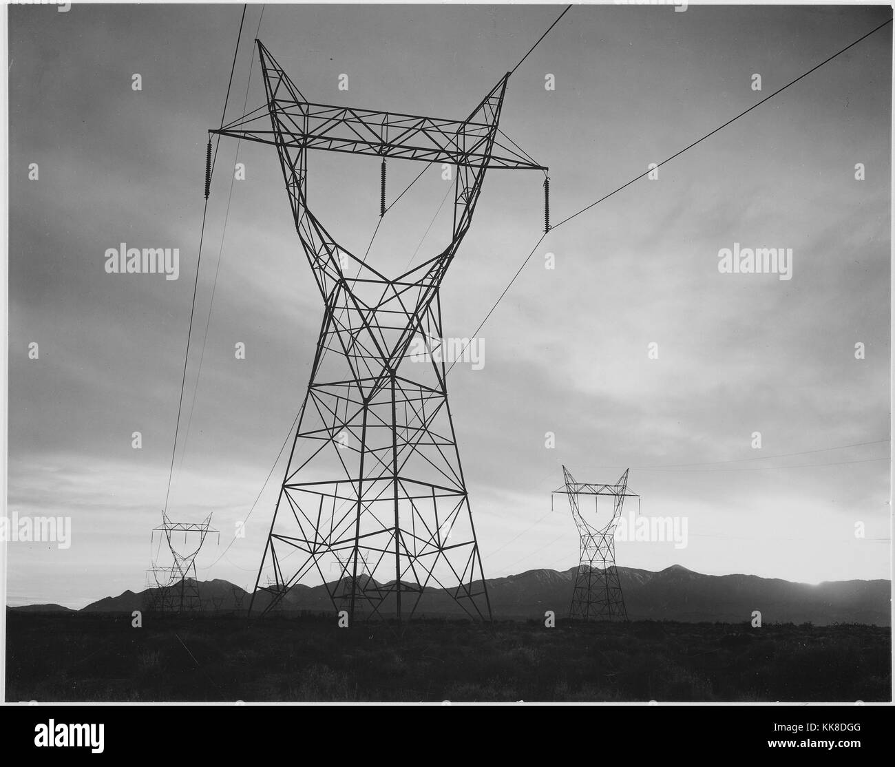 Photograph of Transmission Lines in Mojave Desert Leading from Boulder Dam, Ansel Adams Photographs of National Parks and Monuments. Image courtesy National Archives, 1941. Stock Photo