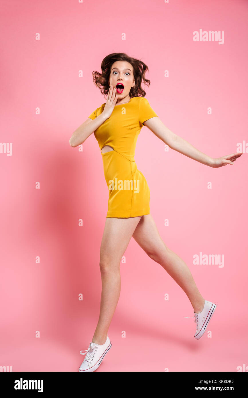 Full length portrait of surprised beautiful young woman in elegant ...