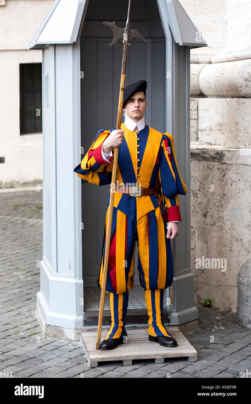 Vatican, November 19, 2017: Swiss Guards standing by a gate at Saint Peters Square. Stock Photo