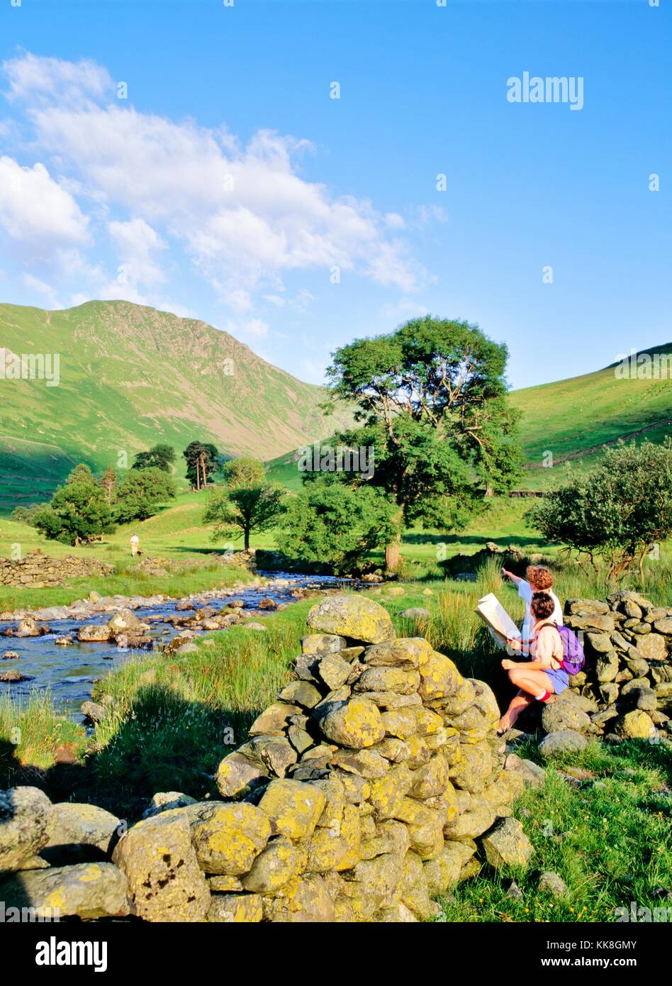 Fell walkers plan their trail route near Hartsop, south of Ullswater, in the Lake District National Park, Cumbria, England. Stock Photo