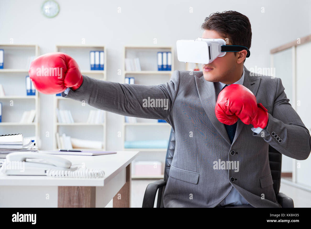 Man boxing in the office with virtual reality goggles Stock Photo Alamy
