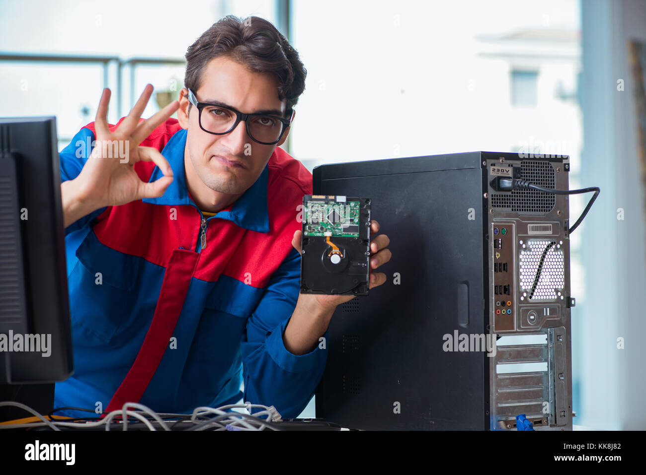 Computer Rebort Man Computer repairman working on repairing computer in IT workshop Stock ...
