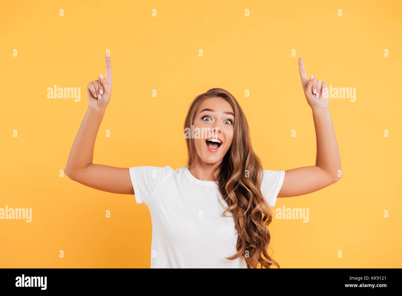 Photo of excited surprised beautiful young woman standing and posing ...