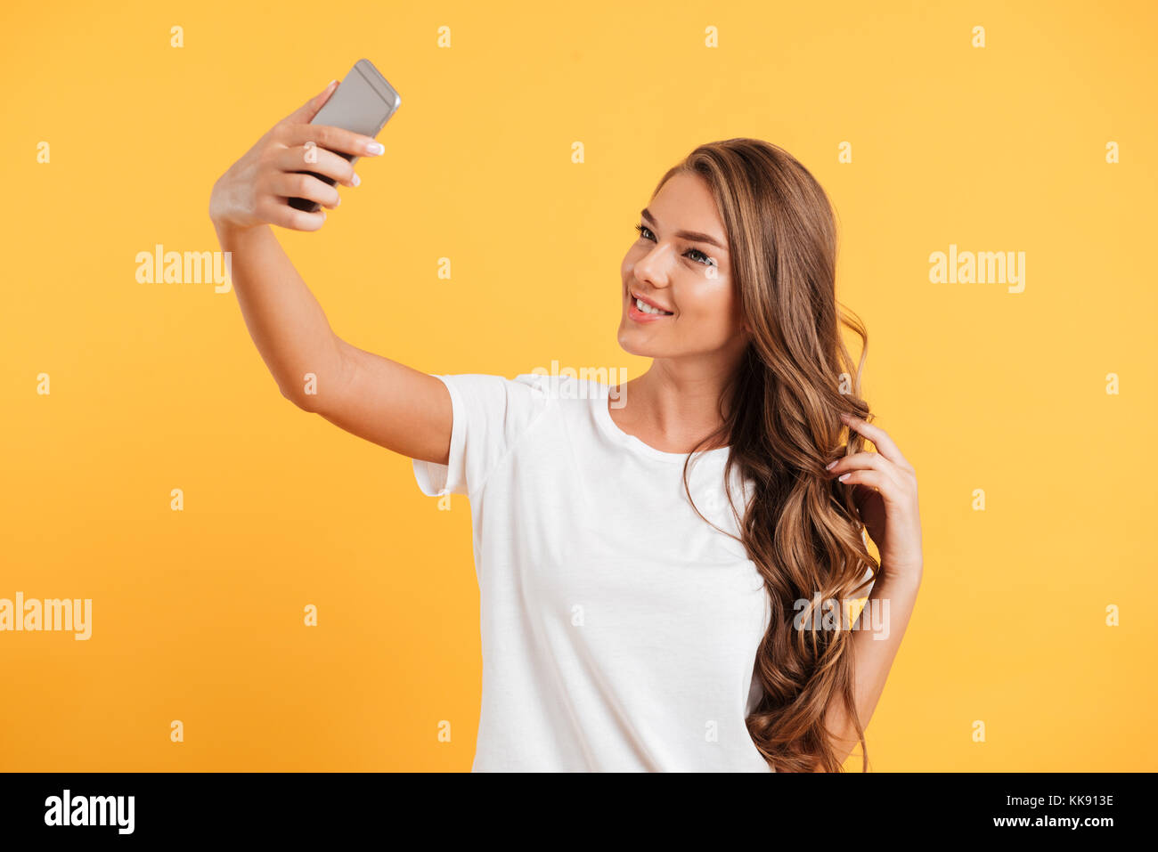 Photo of pretty cute beautiful young woman make selfie by mobile phone ...