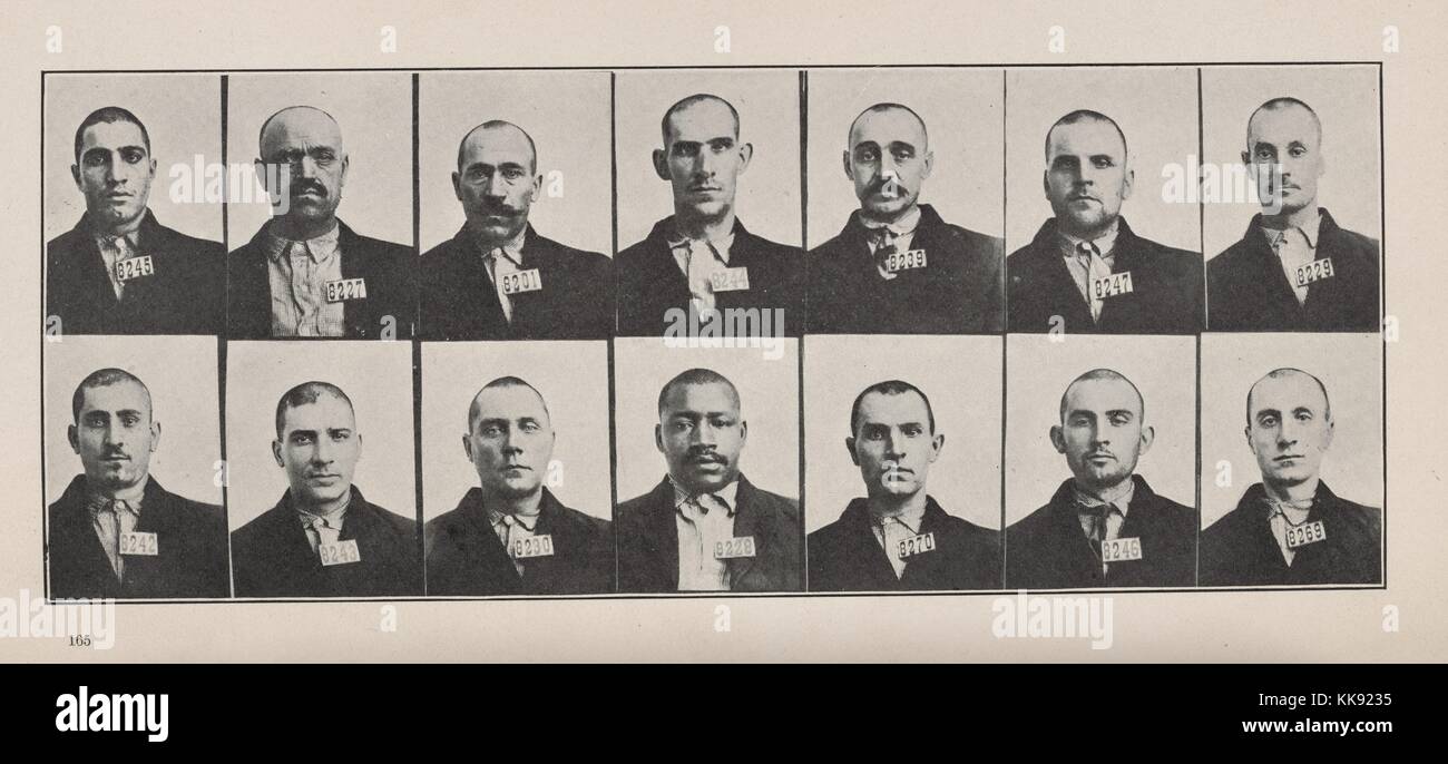 An array of portrait photographs of coal miners, each miner has a shaved head and wears a deark jacket and light colored button down shirt, they all also have a unique four digit number displayed on their jacket, 1913. From the New York Public Library. Stock Photo