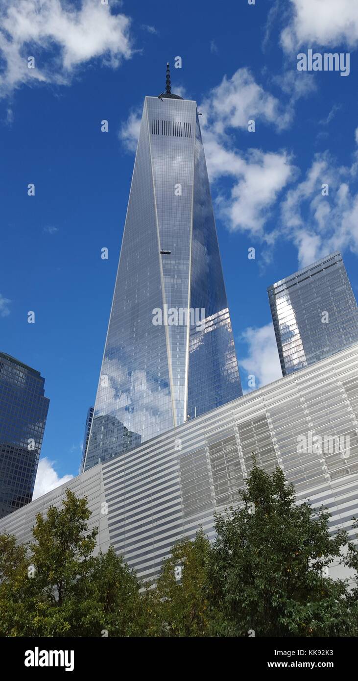 A photograph of the exterior of One World Trade Center and the National September 11 Museum, the tower is the mail building in the rebuilt World Trade Center complex in Manhattan, the tower with its spire is 1776 feet tall and opened in 2014, the museum was also opened to the public in 2014 and houses images and artifacts of the September 11 attack as well as oral histories of the people killed in the attacks, New York, New York, October 17, 2015. Stock Photo