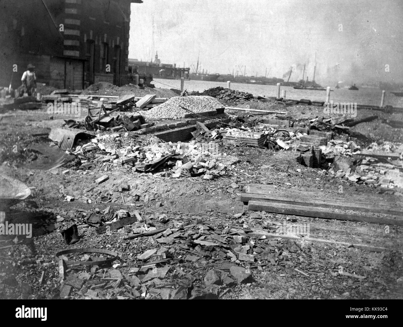 A view of construction materials and rubble laying on the ground outside of one of the buildings on Ellis Island, Ellis Island was the busiest point of immigration in the United States from 1892 until it closed in 1954 after processing over 12 million immigrants, New York, 1907. From the New York Public Library. Stock Photo