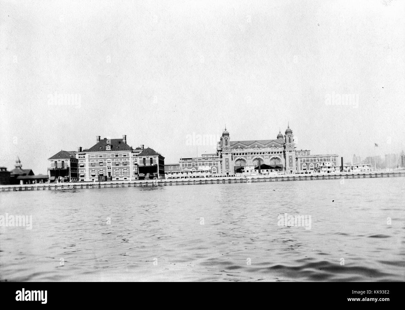 A photograph of Ellis Island taken from the Upper New York Bay, the large building on the left is the hospital building, it was used to treat immigrants who were ill, if they could be cured they were allowed in to the United States otherwise they were sent back to their home country, the sprawling building on the right is the immigration inspection station, between 1892 and 1954 over 12 million immigrants were processed through Ellis Island making it the busiest point of immigration in the country, New York, 1907. From the New York Public Library. Stock Photo
