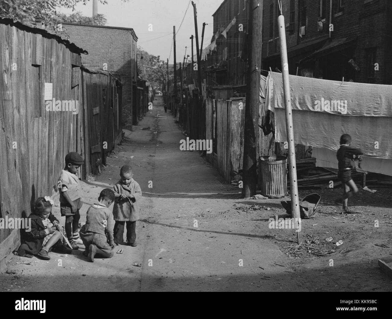 Black and white photograph of African-American children playing in the Defrees Alley, NE, near the Capitol Building, Washington, DC, 1877. From the New York Public Library. Stock Photo