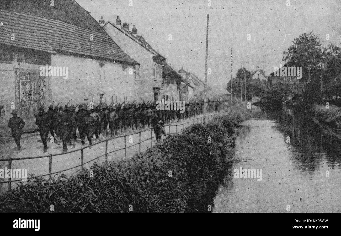 Black and white photograph of a large group of African-American soldiers marching along the side of a river, France, 1919. From the New York Public Library. Stock Photo