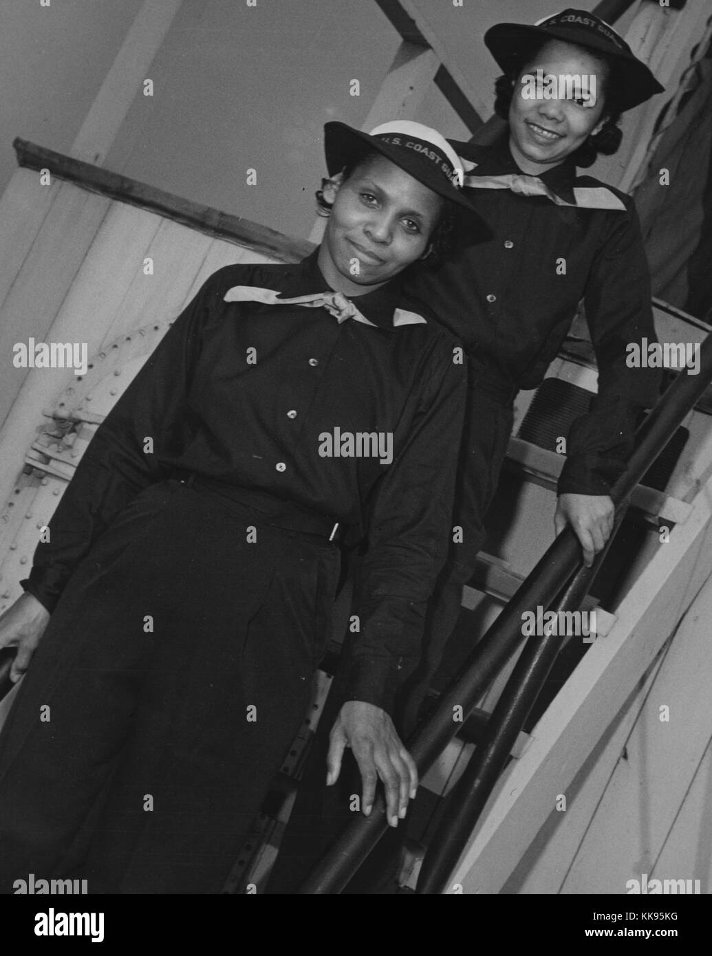 A photograph of Olivia Hooker and Aileen Anita Cooke in United States Coast Guard uniforms, on the left is Hooker who was the first African-American woman to join the United States Coast Guard, she was a member of the United States Coast Guard Womens Reserve which was known as SPARS until 1946 when her unit was disbanded, Cooke appears behind her on the right, they are aboard the USS Neversail which was a USCG dry-land training ship, Brooklyn, New York, 1943. From the New York Public Library. Stock Photo