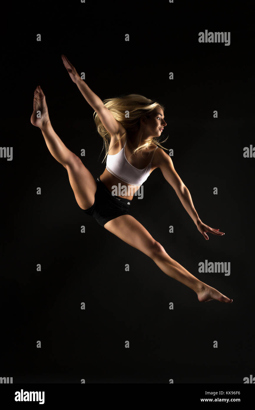 Studio dancing female mid air jumps Stock Photo