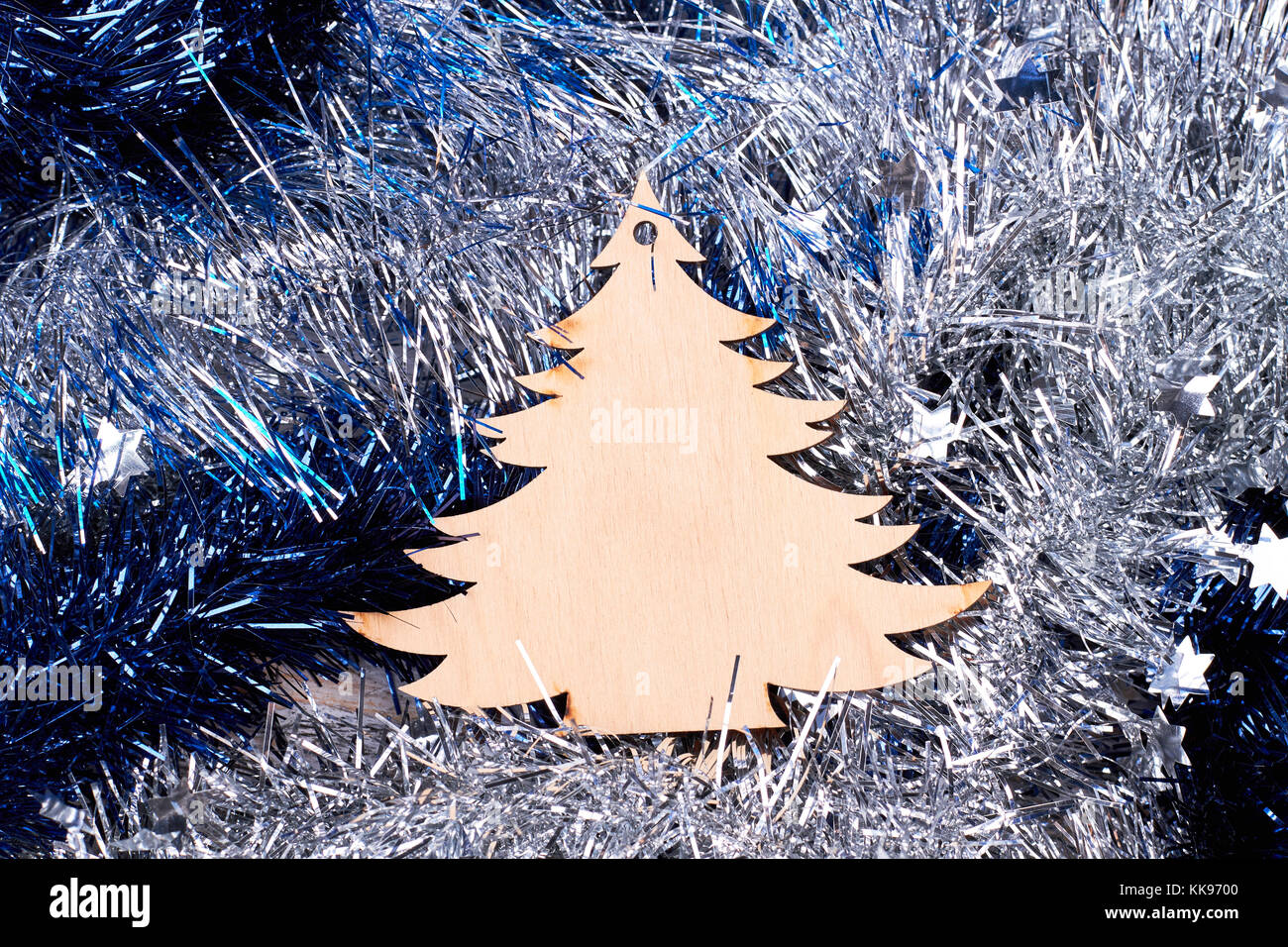 Cut out wooden pine on tinsels background. Stock Photo
