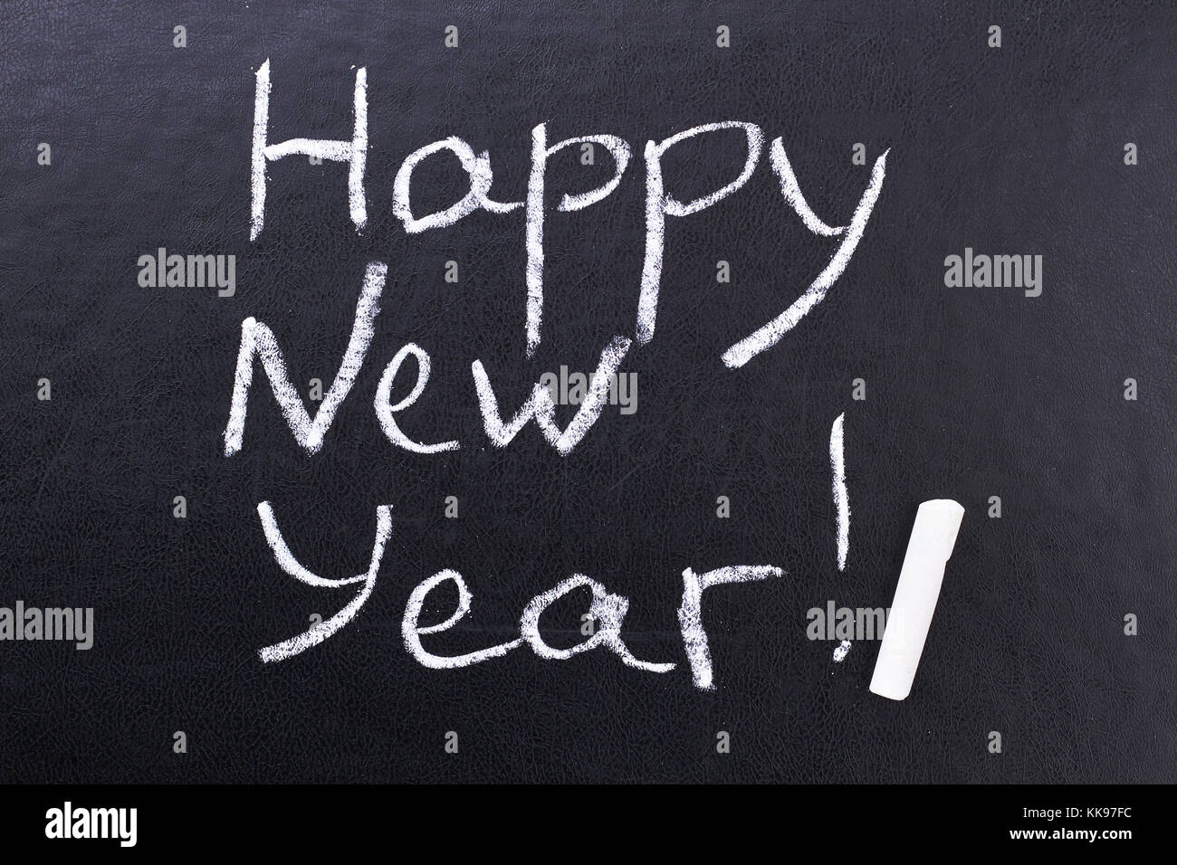 Inscription Happy New Year on black board. Stock Photo