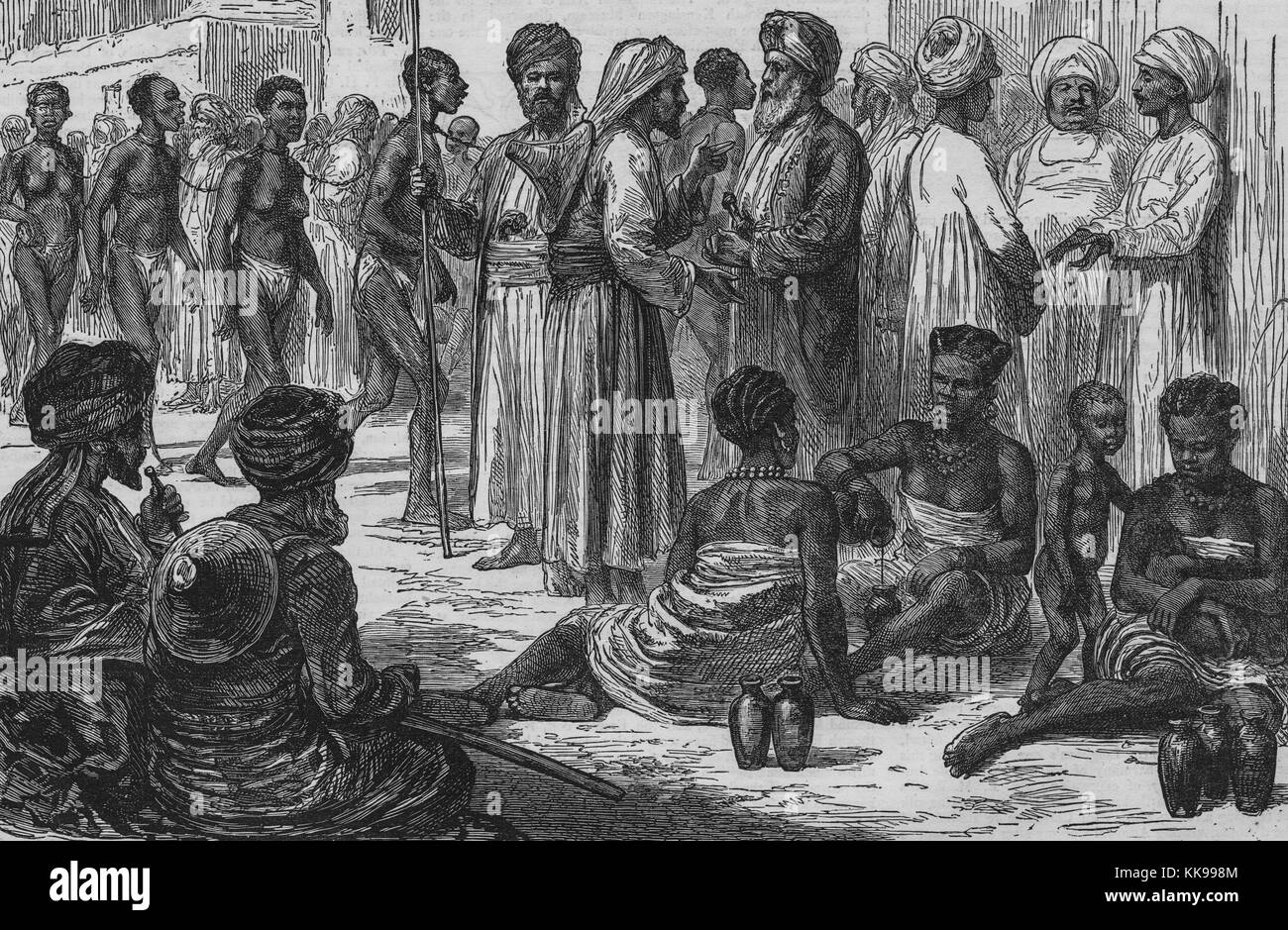 An etching that shows Arab slave dealers and slaves, the slaves are seen in two groups, the group on the left are men and women wearing only breech cloths, the group on the right are three fully clothed women and two small children, the slave dealers all wear long pieces of light colored clothing and turbans, Zanzibar, 1873. From the New York Public Library. Stock Photo