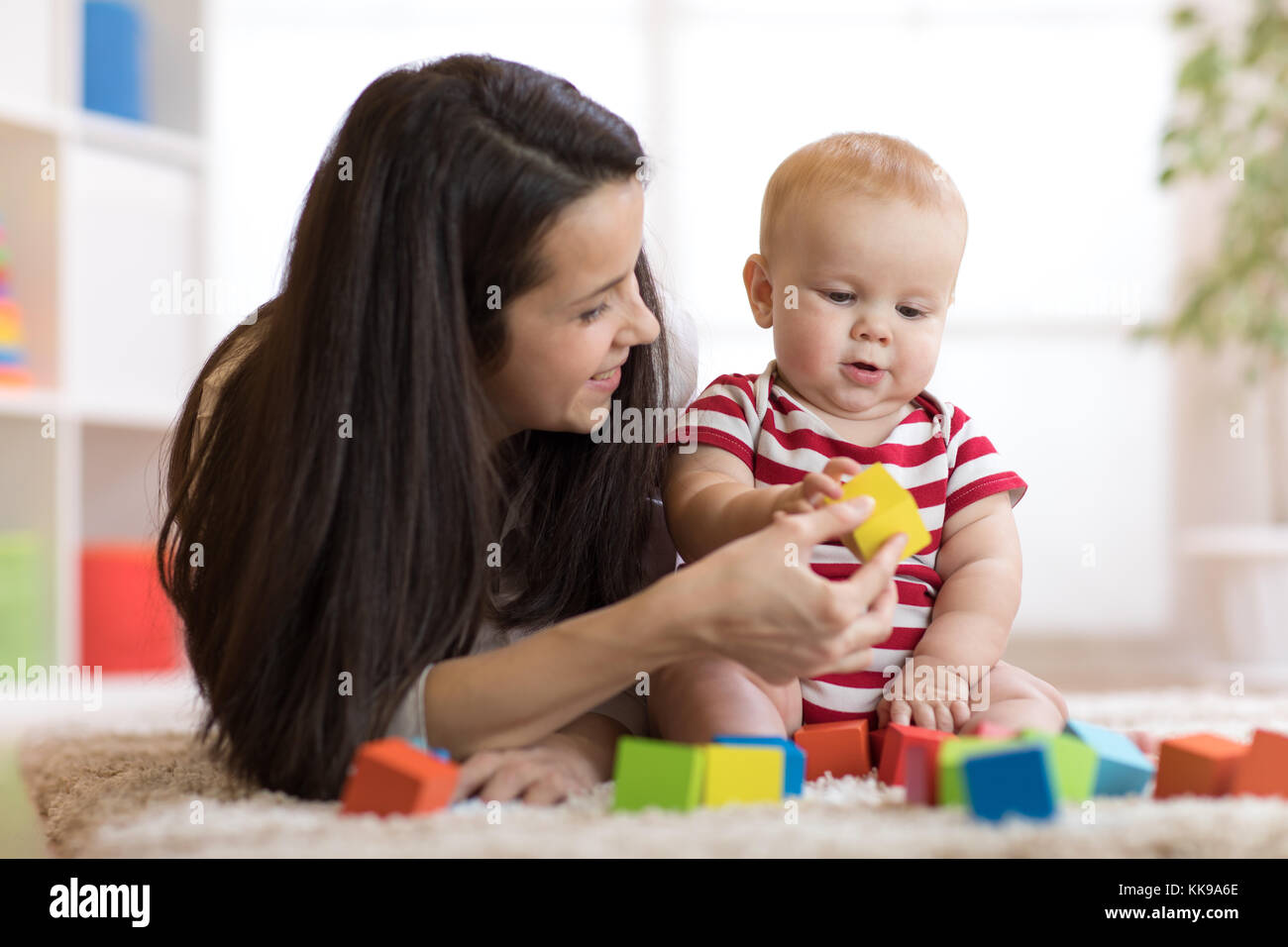 Mother with baby boy playing at home Stock Photo - Alamy