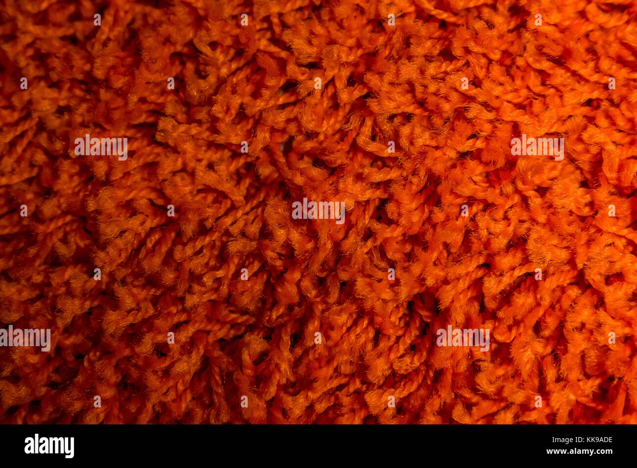 Close up of bright red domestic woolen carpet texture Stock Photo