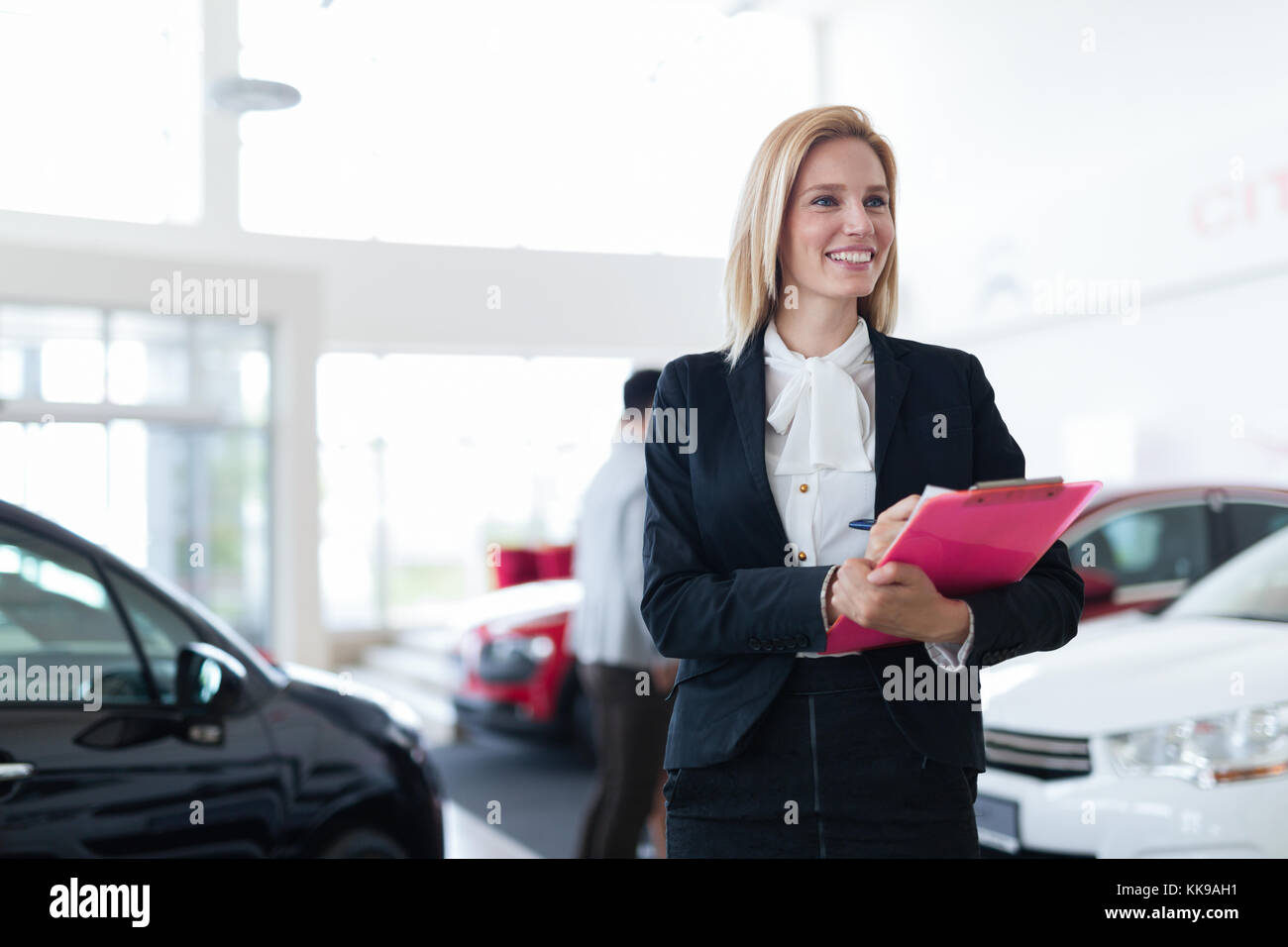 Picture of professional salesperson working in car dealership Stock