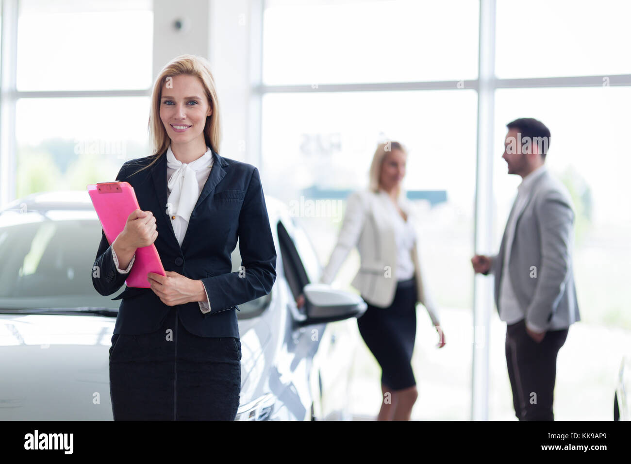 Picture of professional salesperson working in car dealership Stock
