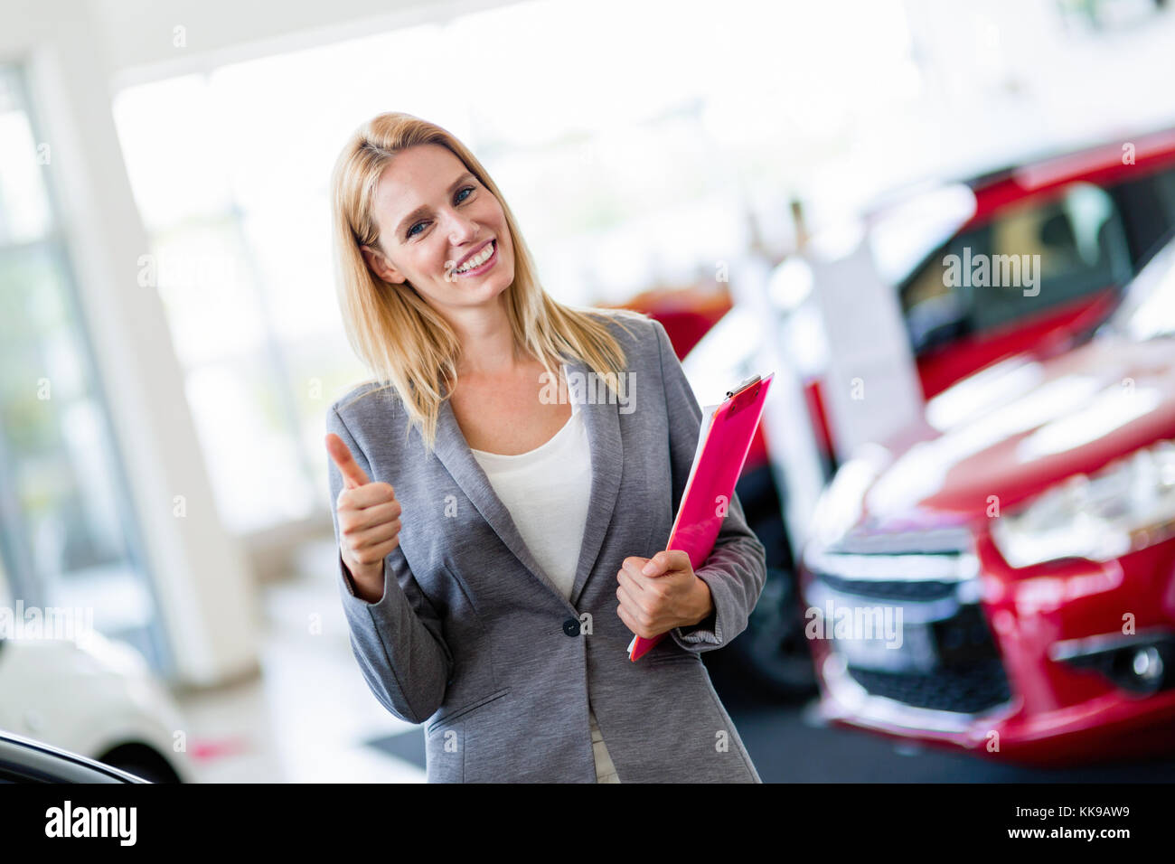 Picture of professional salesperson working in car dealership Stock