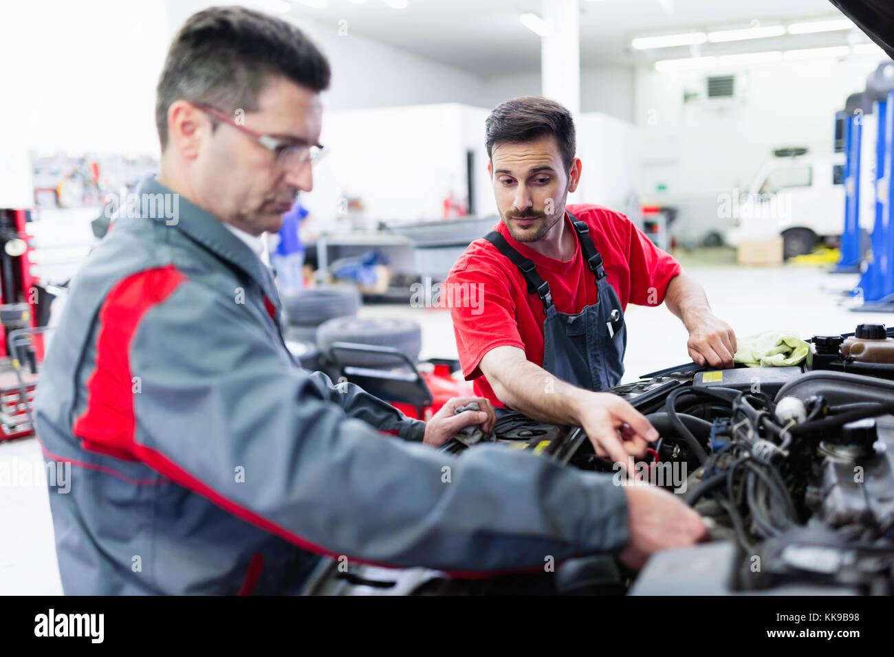 Car Mechanics Working At Automotive Service Center Stock Photo