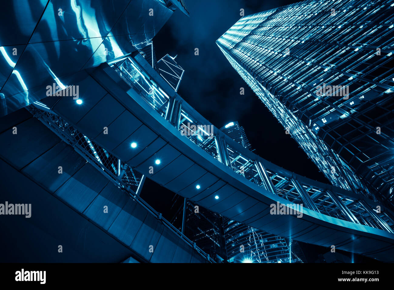 Blue toned modern cityscape at night with illuminated skyscrapers, high ...