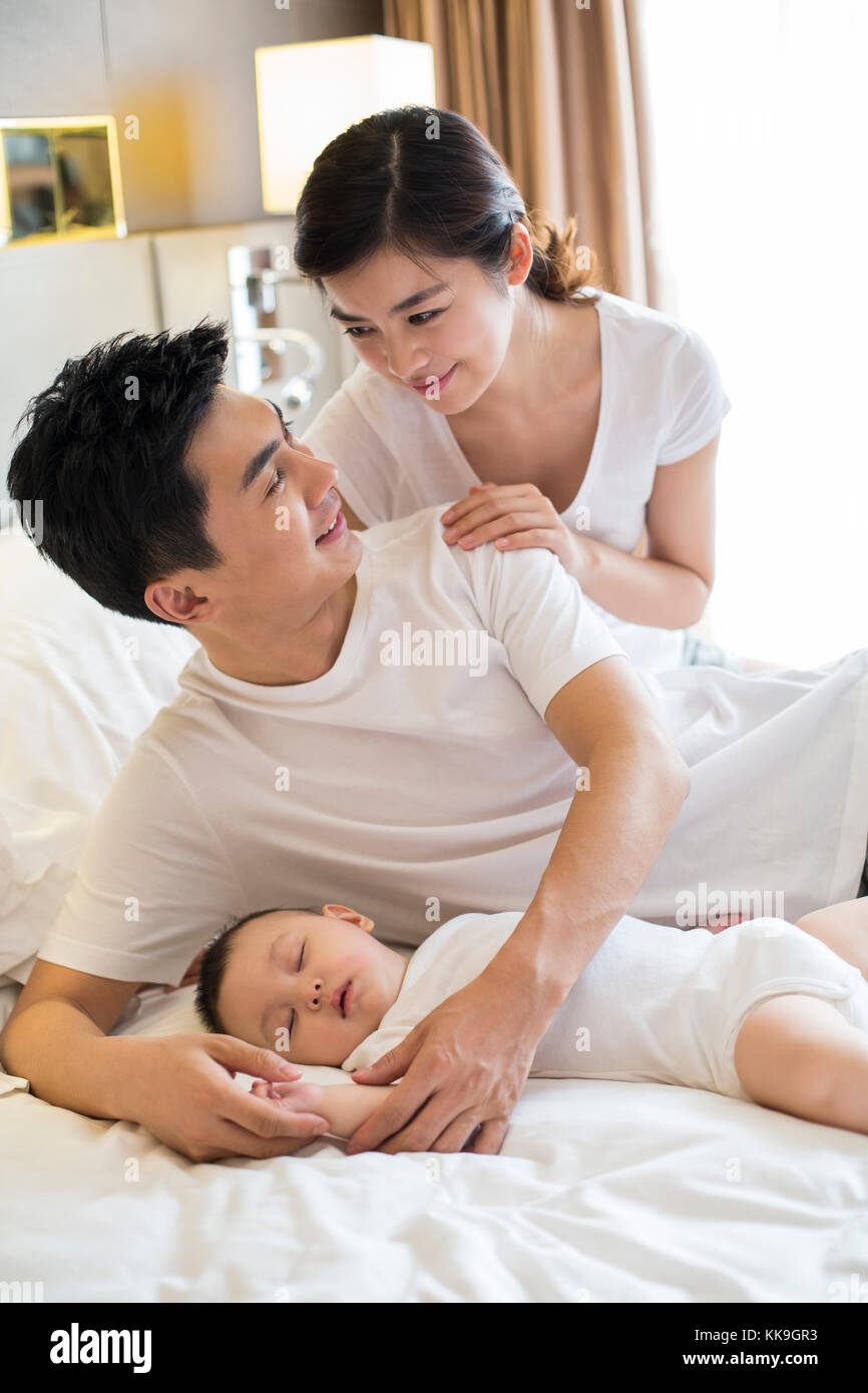 Young Chinese Parents With Sleeping Baby Boy Stock Photo Alamy