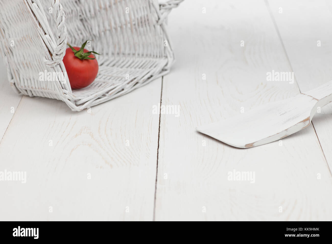 tomatoes in a white basket on a white background Stock Photo - Alamy