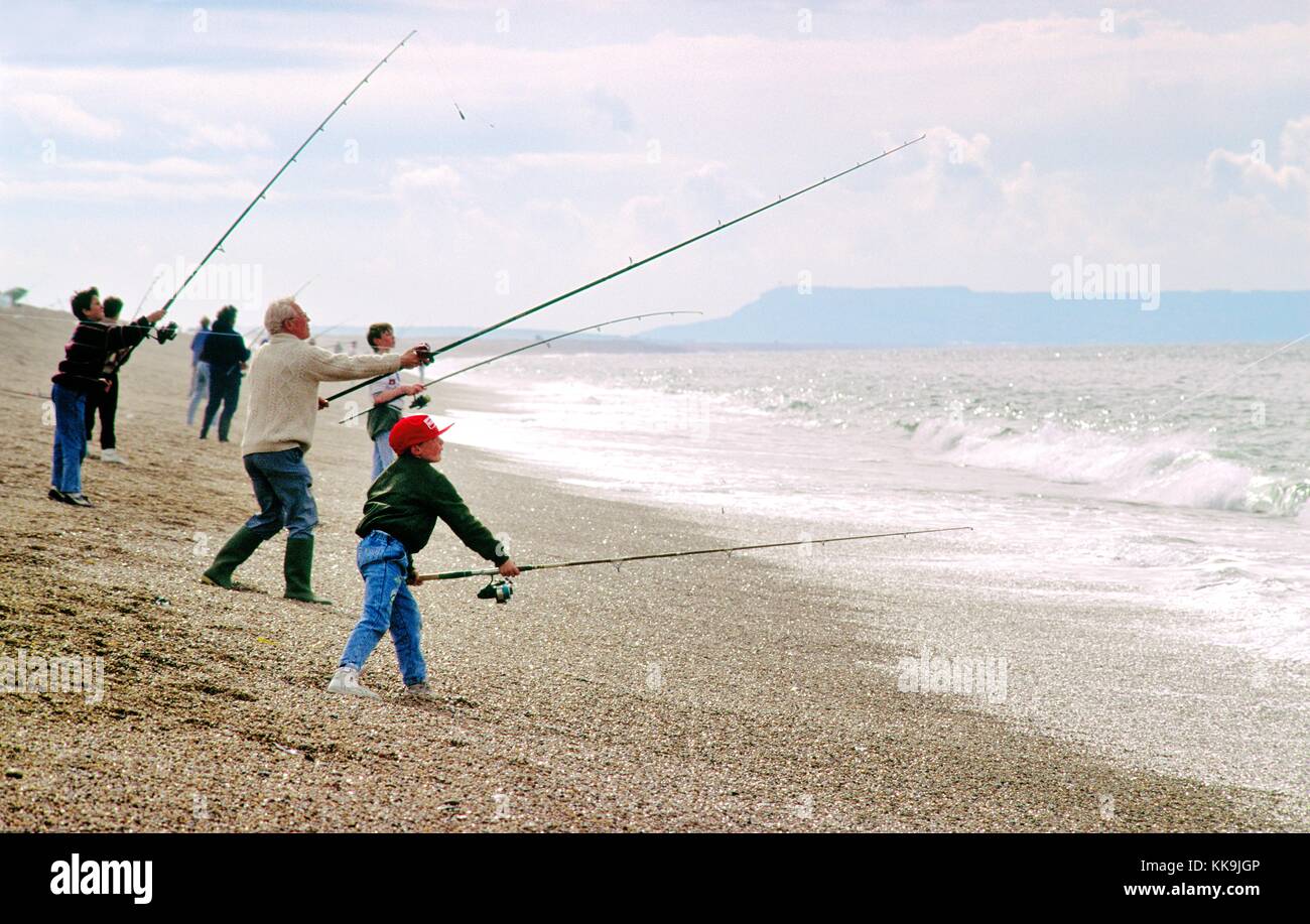 Sea angling fishing casting on Chesil Beach on English Channel coast of
