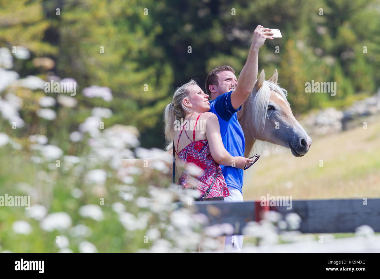 Nauders, Austria- August 5, 2017 : Couple taking picture of them by using smart phone in the mountains at Nauders, Austria Stock Photo