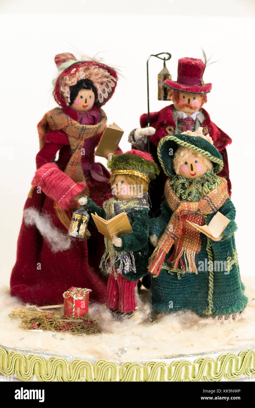 A Christmas festive decoration crafted from wooden pegs and assorted coloured fabrics, representing a family of four singing carols at Christmas Stock Photo