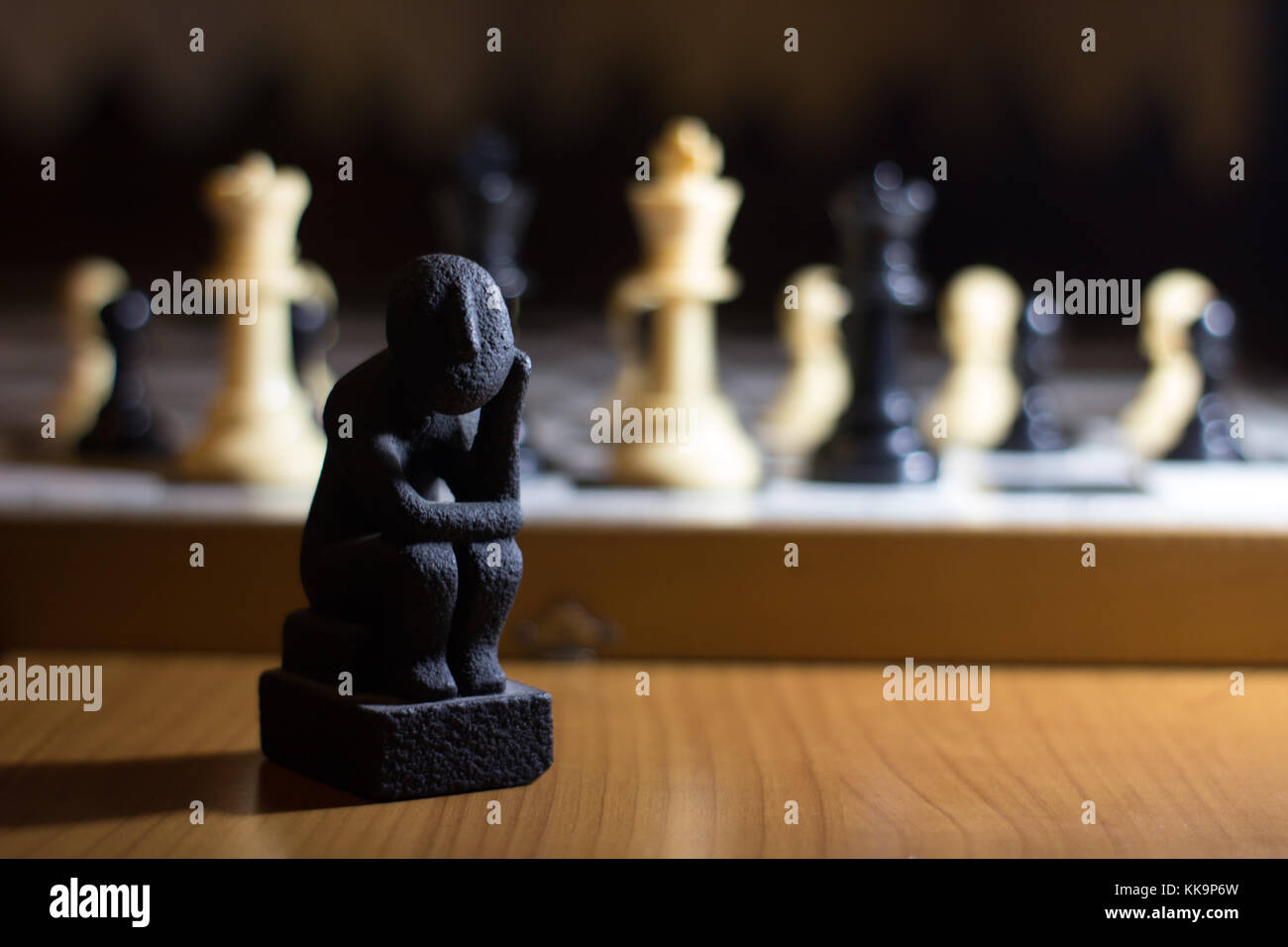 the thinker statue on a chess board coil small thinking about strategy  solution Stock Photo