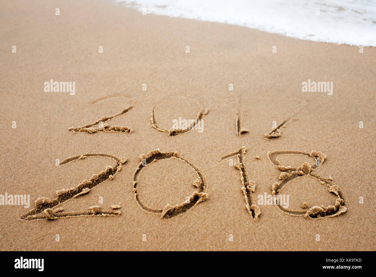 Concept of holidays. Happy New Year 2018 replace 2017 on the sea beach Stock Photo
