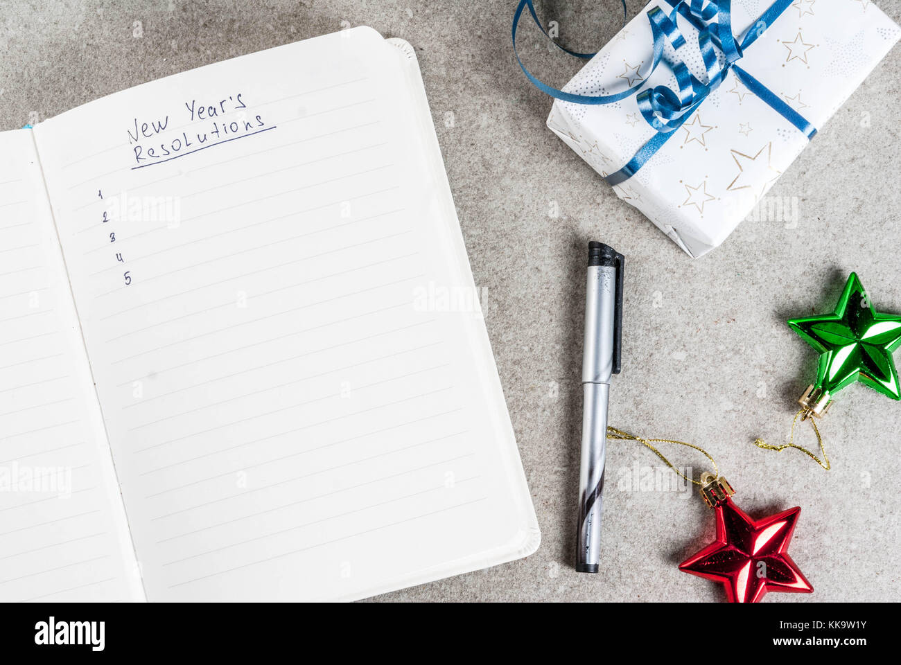 New years resolutions concept, open notebook on a grey stone table ...
