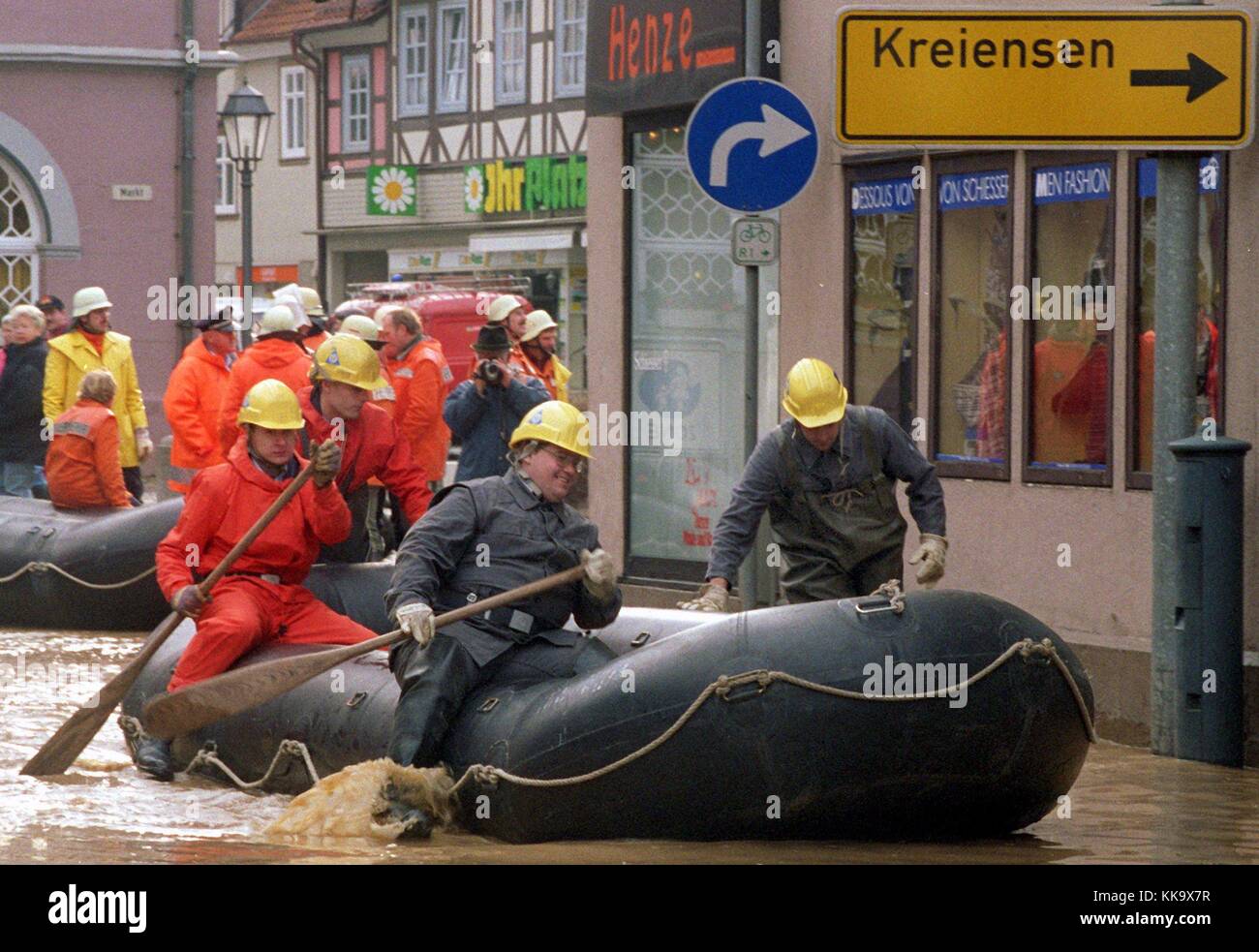 Rescue workers are forced to use rubber boats to reach flooded streets ...
