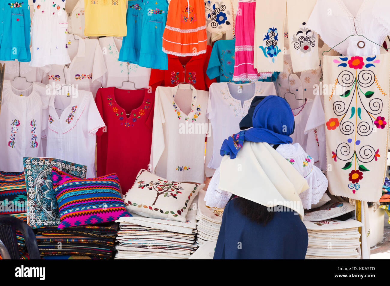 Otavalo Market, woman stall holder and clothing stall, Otavalo,  Ecuador South America Stock Photo