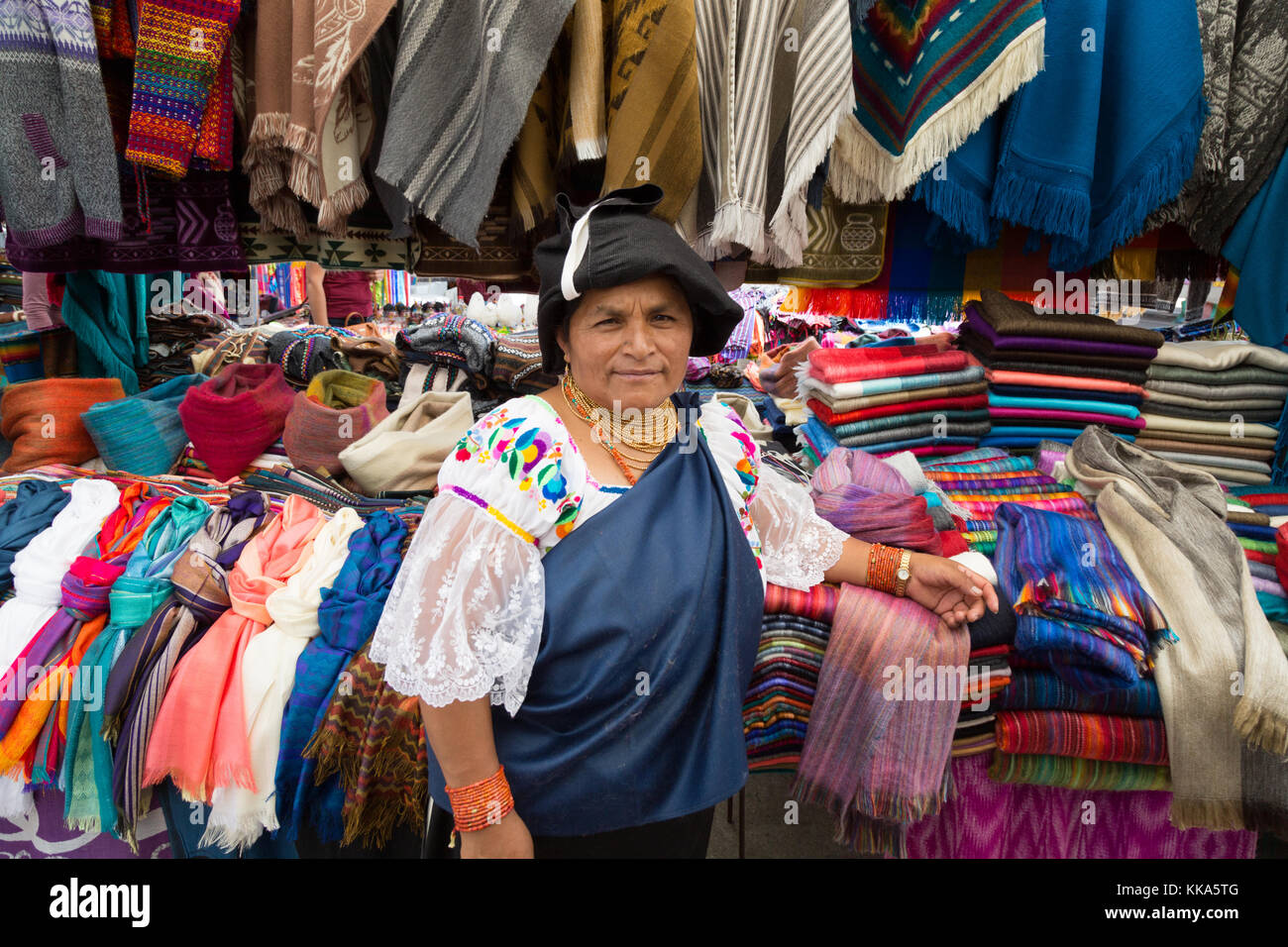 Otavalo market Woman in traditional costume of the indigenous people selling clothes from her stall, Otavalo Market, Ecuador, South America Stock Photo