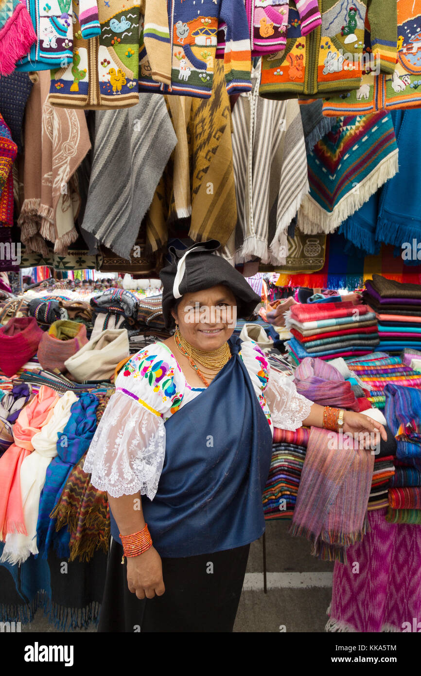 Otavalo market Woman in traditional costume of the indigenous people selling clothes from her stall, Otavalo Market, Ecuador, South America Stock Photo