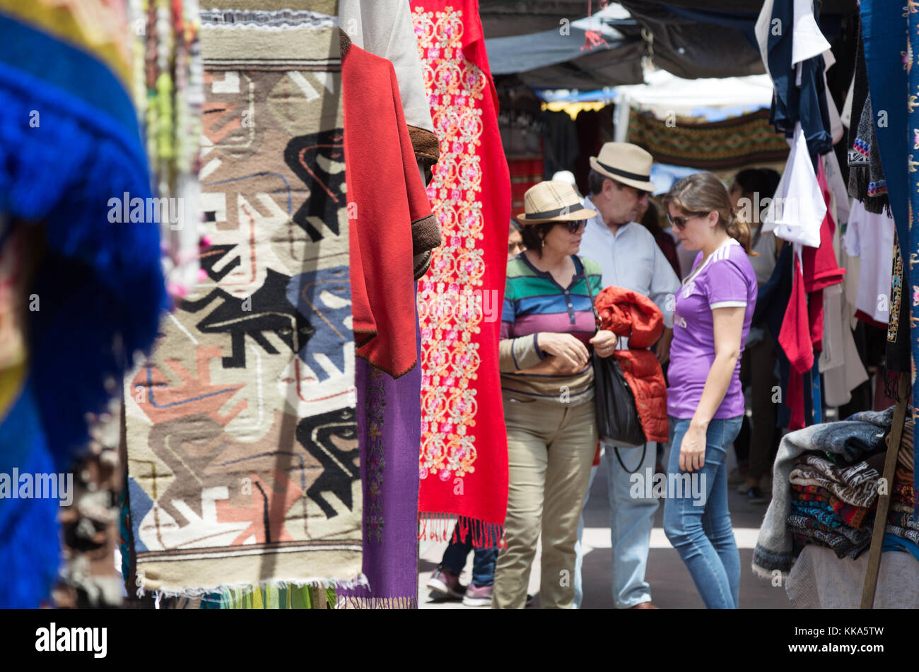 Ecuador tourists - Tourists buying goods, Otavalo market, Otavalo, Ecuador, South America Stock Photo