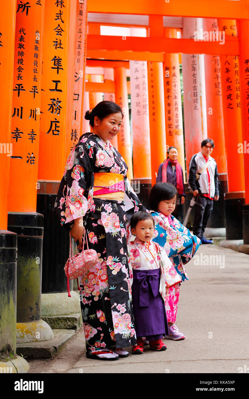 Japanese family dressed in traditional Kimono in Fushimi Inari, a path